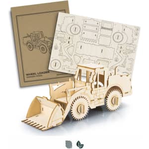A wooden model of a wheel loader in natural finish, accompanied by a flat packaging with design patterns.