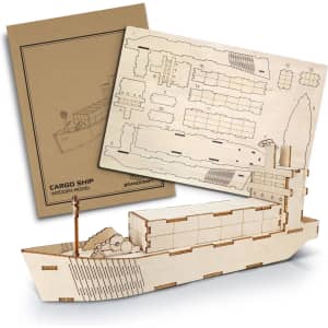 A wooden model of a cargo ship, unassembled parts and packaging displayed, featuring natural wood colour.