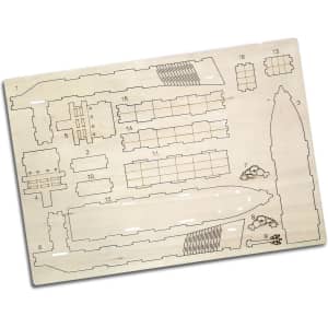 A wooden model kit of a cargo ship with various pre-cut pieces on a light wood base.