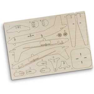 A wooden model kit of a jet plane featuring various parts arranged on a light wood board, including wings and fuselage sections.
