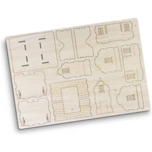 A wooden model kit featuring laser-cut pieces for assembling a house. The model is light beige in colour.