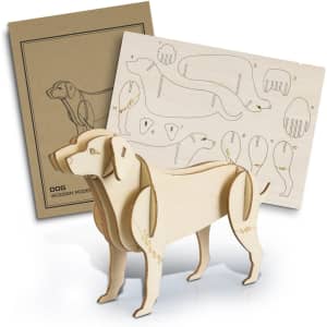 A wooden dog model stands beside its assembly template, crafted from light-coloured wood with detailed cutouts.