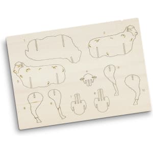 A wooden model kit featuring sheep-shaped pieces, intricate engravings, and numbered sections for assembly.