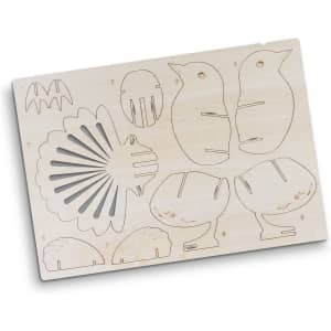 A wooden model kit featuring shaped cutouts, including animals and shell designs, in a light wood finish.