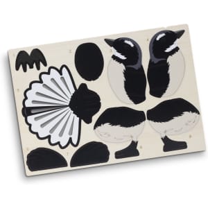 A wooden model kit featuring black and white pieces for assembling a fantail bird, with a natural wood base.
