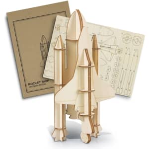 A wooden model of a rocket ship in natural wood tones, accompanied by a detailed instruction sheet.