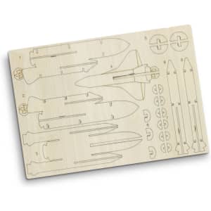 A wooden model kit featuring a rocket ship and rocket parts, with a natural wood finish and precise cutouts.