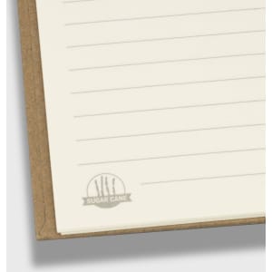 A spiral notebook with a natural brown cover and lined pages, featuring a logo at the bottom corner.