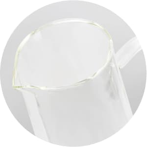 A drink bottle made of clear glass with a pour spout, featuring a minimalistic design and a logo.