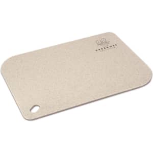 A chopping board in a light beige colour with a rounded edge and a hole for hanging, featuring a logo.