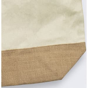 A tote bag with a cream canvas upper and a textured brown hessian lower section, featuring a logo.