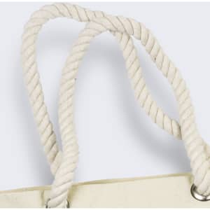 A close-up of the twisted, cream-coloured rope handles of a tote bag featuring silver eyelets.