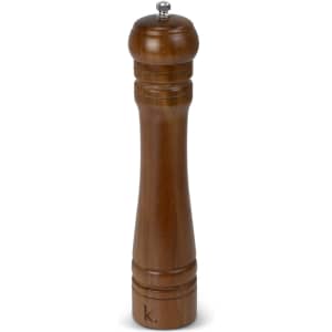 A wooden pepper mill in a warm brown finish, featuring a rounded top and elegant grooves. It has a logo on the base.