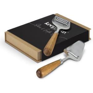 A slicer and grater set with wooden handles and a black presentation box featuring a logo.