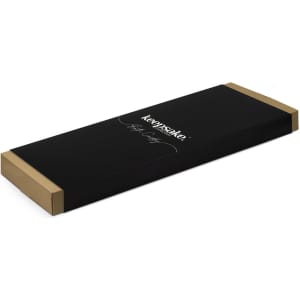 A sleek black packaging box with a gold trim for the Keepsake Bath Caddy, featuring a logo.