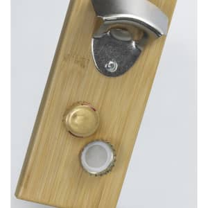A drink bottle opener made of bamboo featuring a metallic bottle cap opener and two bottle caps.
