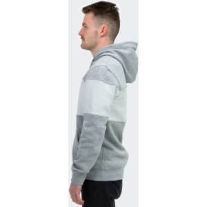 A grey and white unisex hoodie featuring a logo, displayed on a model from the side.