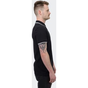 A black polo shirt with contrasting white accents, featuring a logo, showcased on a male model from the side.