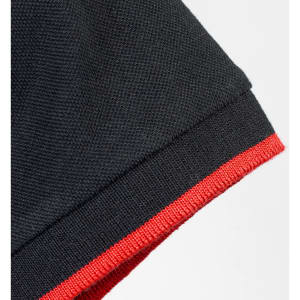 A black polo shirt featuring a red trim on the collar and sleeve. It has a branding logo.