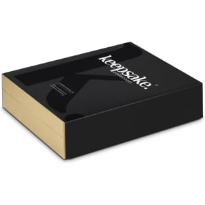 A black and gold rectangular box with a logo, containing a cocktail set for home use.