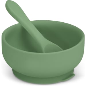 A green suction bowl set for kids featuring a matching spoon. Designed for stability, it includes a logo.