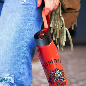 A drink bottle in vibrant red, featuring a black lid and a handle, with an artistic design on its surface.
