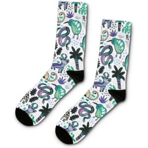 A pair of crew socks featuring a vibrant design with green, purple, and black motifs, including animals and plants.