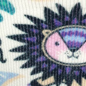 A close-up of a patterned sock featuring a colourful lion design with purple and pink accents.