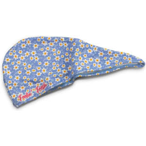 A blue hair towel with a floral pattern, featuring daisies in white and yellow, and a logo.