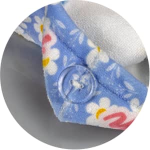 A blue hair towel with a floral pattern and a button closure, made of soft, absorbent material.