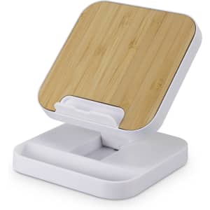 A wireless fast charging stand in white with a bamboo top, designed for phones and technology.