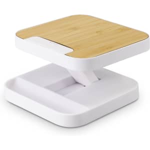 A wireless charging stand with a bamboo top and white base, featuring a sleek, modern design.