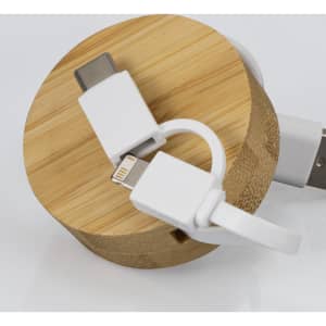 A bamboo circular base with a retractable charging cable featuring white connectors for USB-C and Lightning.