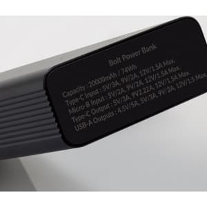 A black power bank with a sleek design, featuring a logo and specifications on one side.