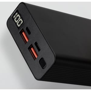 A black power bank with two USB ports, one USB-C port, and a digital display showing battery percentage.