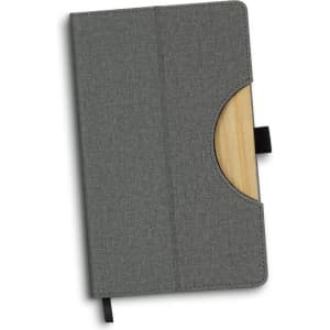 A grey notebook with a wooden accent and a pocket for cards, featuring a ribbon bookmark and a logo.