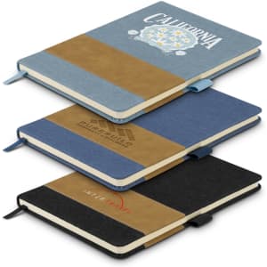 A collection of three denim notebooks in blue, black, and beige, each featuring a logo on the cover.