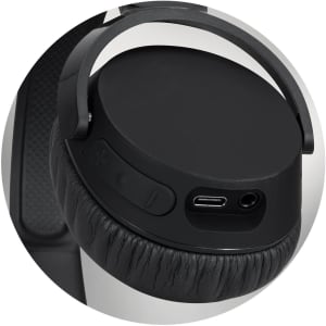 A close-up of black Skullcandy Riff 2 wireless headphones showing the earcup, buttons, and charging port.
