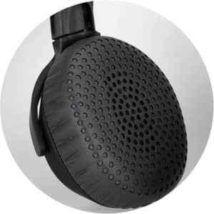 A close-up of a black headphone earcup featuring a textured surface and a circular design pattern.