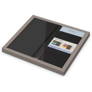 A Moleskine bundle featuring a black sketchbook, colourful art tools, and a logo on the packaging.