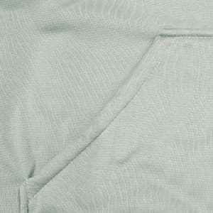 A close-up of a light green fabric featuring a seamless pocket, part of a hoodie design.