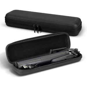 A black carry case containing a compact selfie stick tripod and various accessories inside.