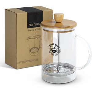 A coffee plunger with a transparent glass body, bamboo lid, and stainless steel components, displayed with its box.