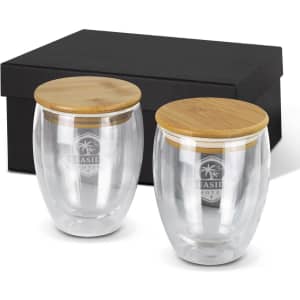 A drink bottle set featuring two clear glass cups with bamboo lids, presented in a black gift box.