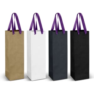 A collection of four paper bags in gold, white, black, and dark green, each with a purple ribbon handle.