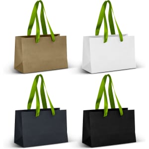 Four small ribbon handle paper bags in olive green, white, navy blue, and black, featuring green handles.