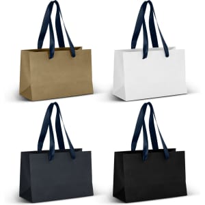 A collection of small ribbon handle paper bags in gold, white, navy, and black with matching ribbon handles.