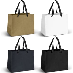 A collection of medium ribbon handle paper bags in gold, white, and black colours. Each has two black handles.