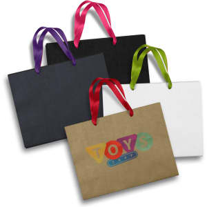 A large paper bag set in black, white, and brown, featuring colourful ribbon handles and a logo.