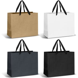 Four large ribbon handle paper bags in brown, white, navy, and black with black handles. Each bag has a plain design.